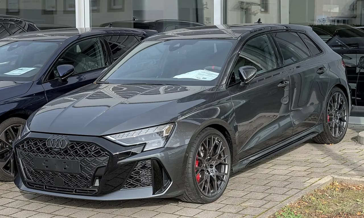 Dark grey 2025 Audi RS3 Sportback (8Y facelift), front three-quarter view