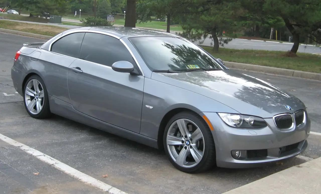 Grey BMW 335i Convertible (E93) with hardtop up, front three-quarter view