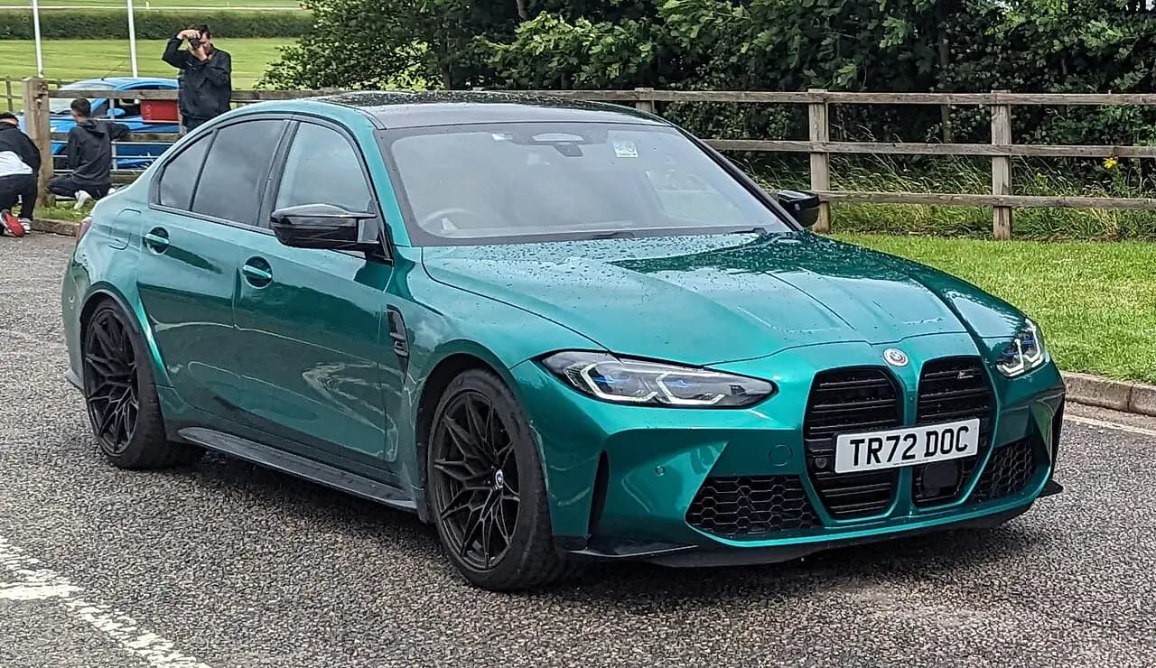 Green 2022 BMW M3 Competition xDrive (G80) sedan, front three-quarter view