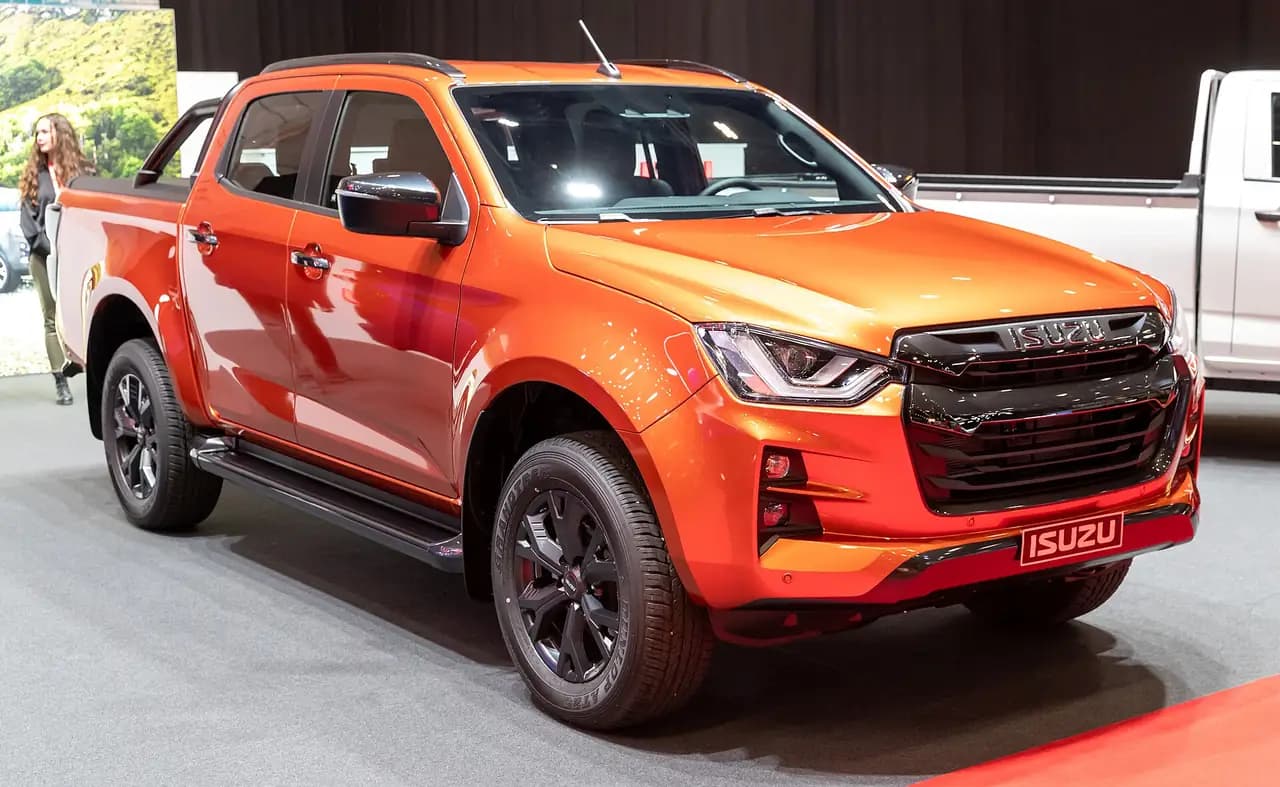 Orange 2024 Isuzu D-Max (RG) crew cab, front three-quarter view