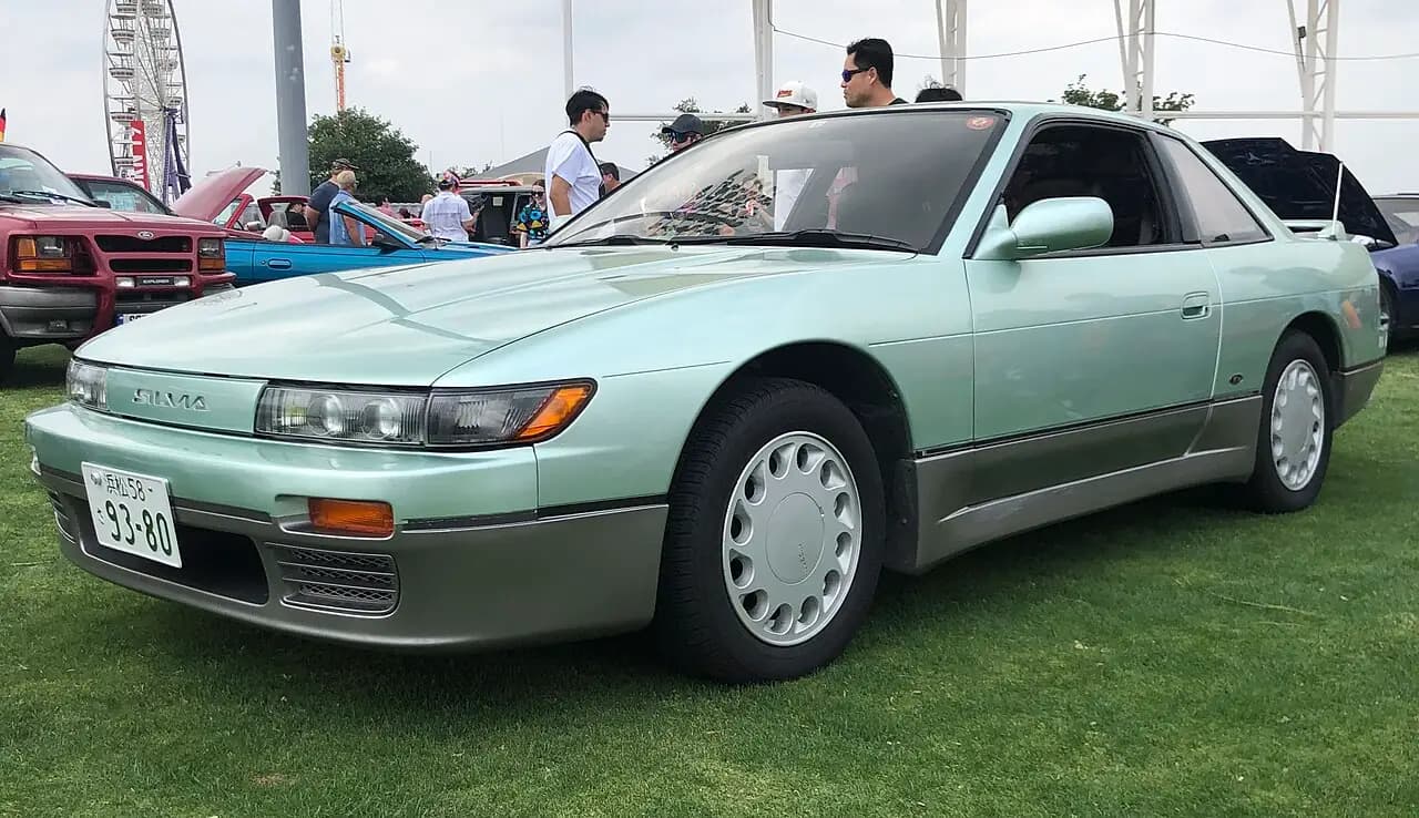 Two-tone pale green Nissan Silvia K's (S13) coupe, front three-quarter view