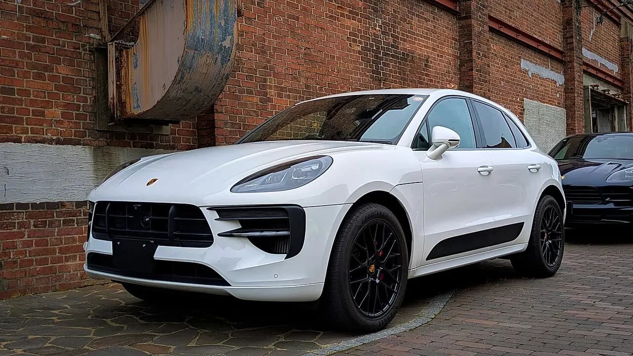 White 2021 Porsche Macan GTS (95B.2) with black wheels, front three-quarter view