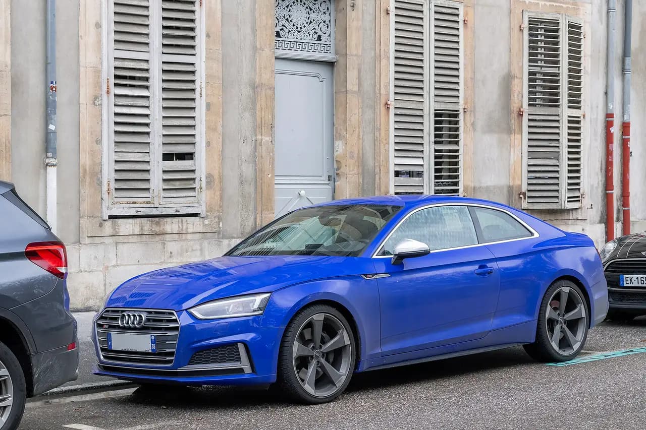 Blue Audi S5 Coupé (B9, pre-facelift) parked on a street, front three-quarter view