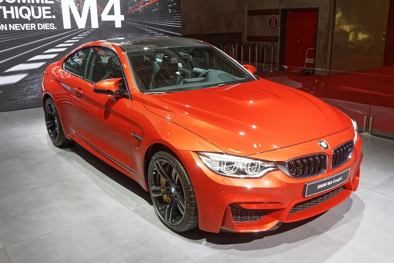 Orange BMW M4 Coupé (F82) at the 2014 Paris Motor Show, front three-quarter view