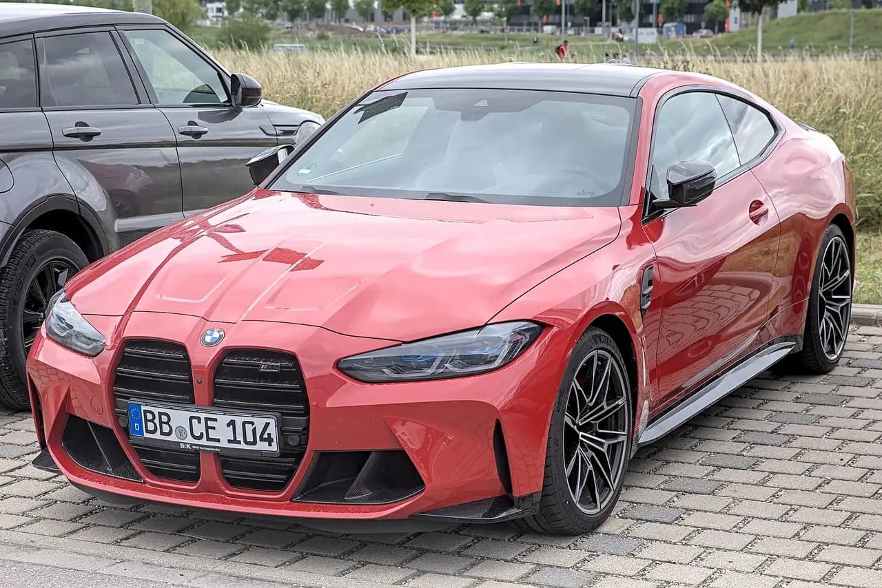 Red BMW M4 Competition Coupé (G82), front three-quarter view