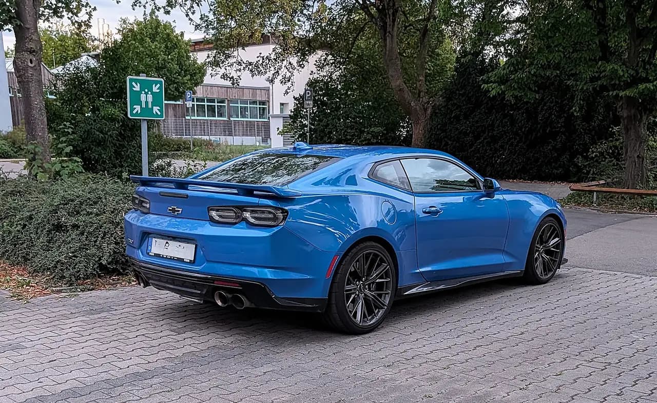 Blue Chevrolet Camaro ZL1 coupe (sixth generation, 2019+ tail lights), rear three-quarter view