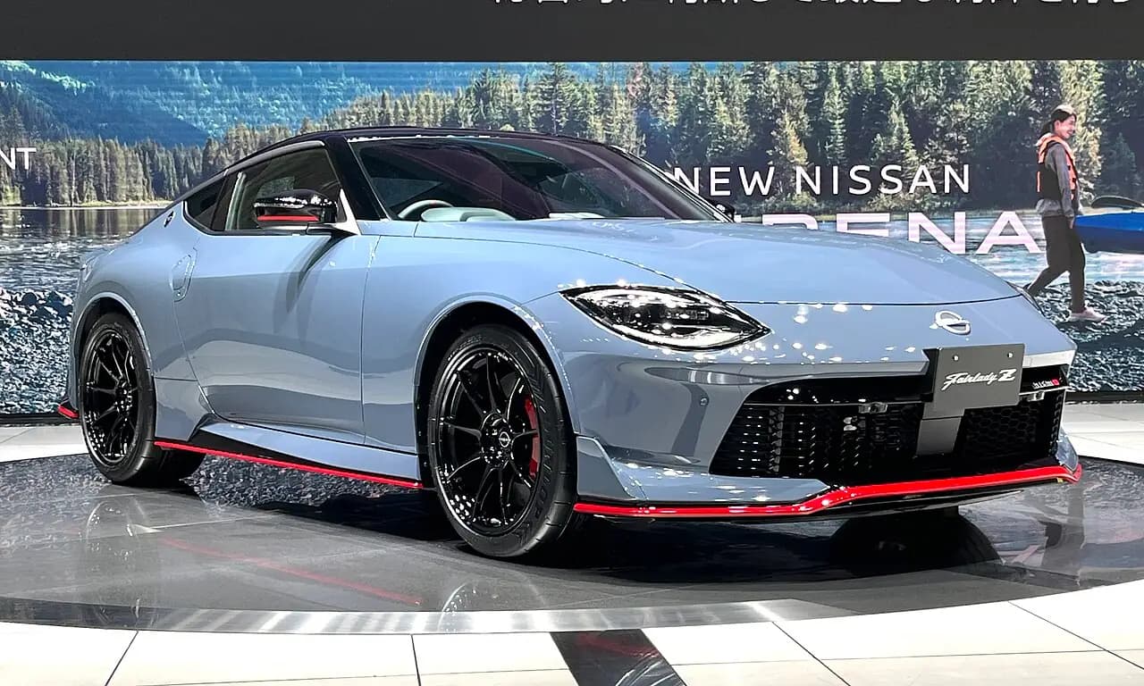 Grey Nissan Z Nismo (RZ34) coupe on a showroom turntable, front three-quarter view