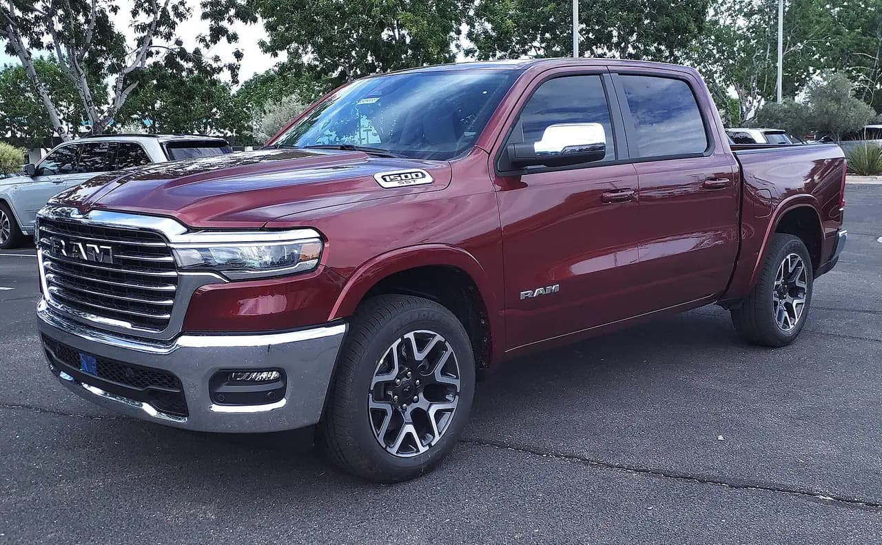 Red 2025 Ram 1500 Laramie crew cab (DT facelift), front three-quarter view