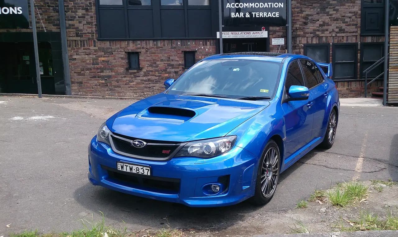 WR Blue Subaru Impreza WRX STI sedan (GV), front three-quarter view