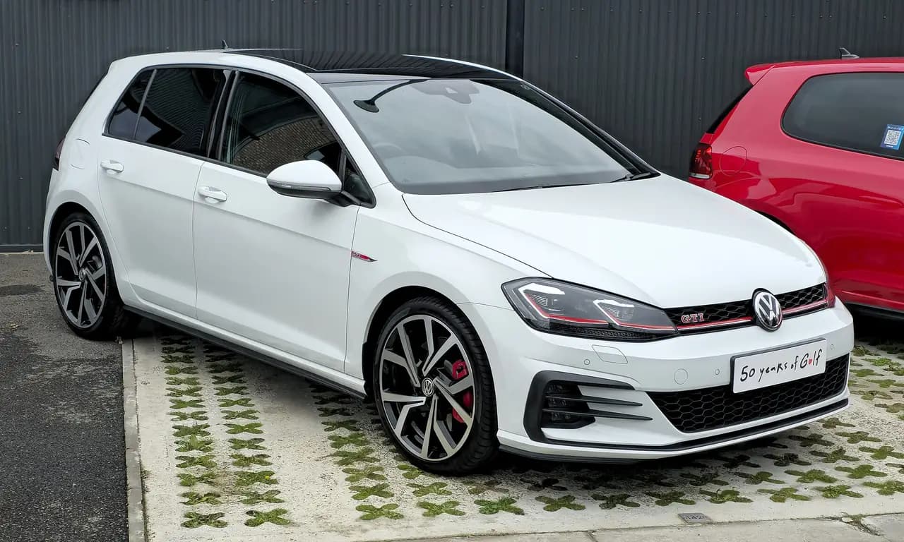 White Volkswagen Golf GTI (Mk7.5) five-door hatchback, front three-quarter view